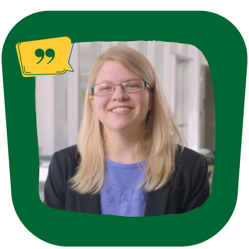 Rebecca Earnhard, blonde white woman searing glasses and a blazer smiling at the camera